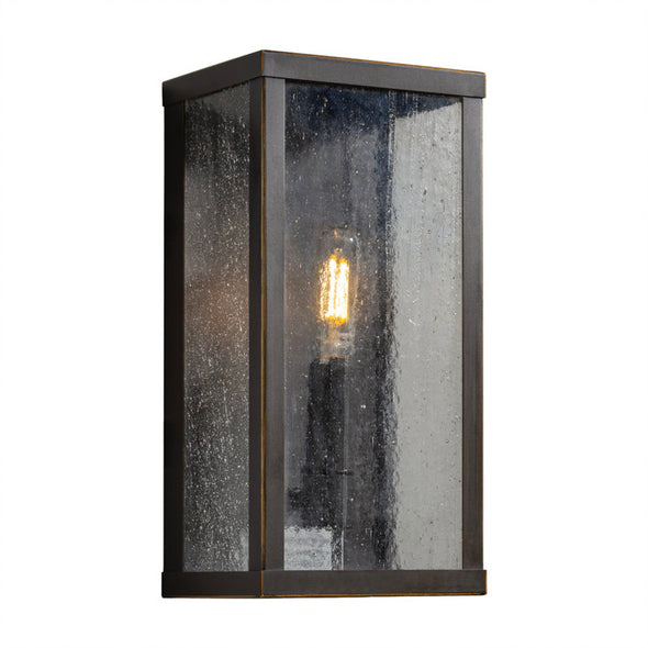 Wall-mounted outdoor light fixture with a glass cover on a white background